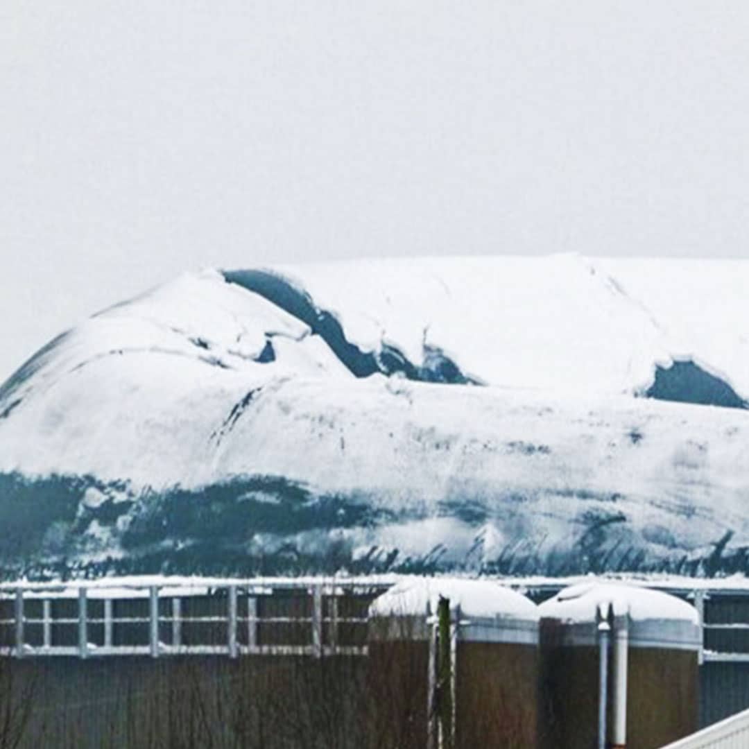 Biogasanlage mit Schnee auf dem eingebrochenen Dach.